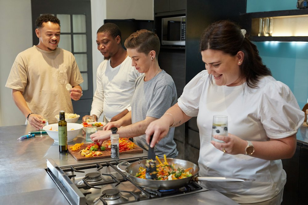A group cooking together in a home kitchen