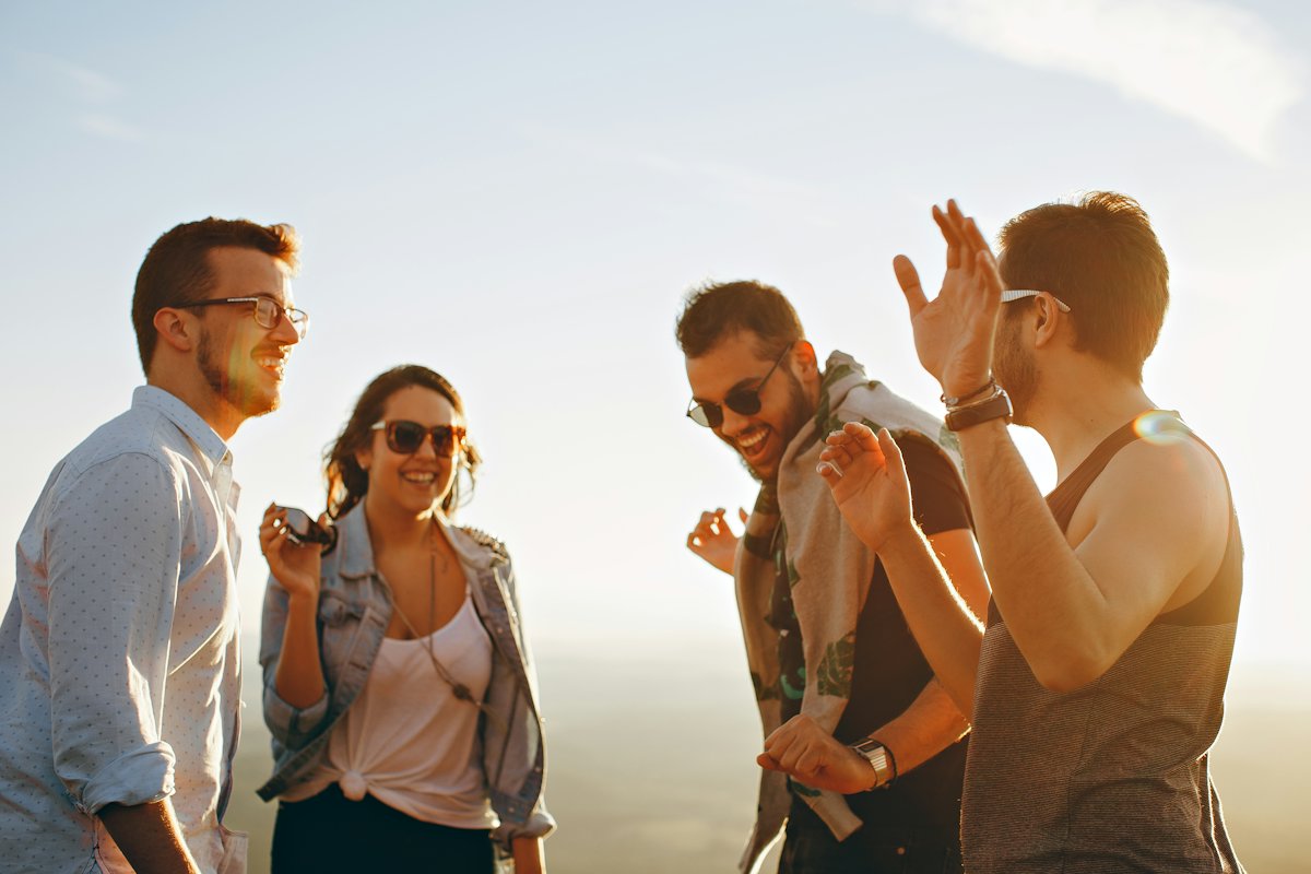 Friends laughing together in warm golden light